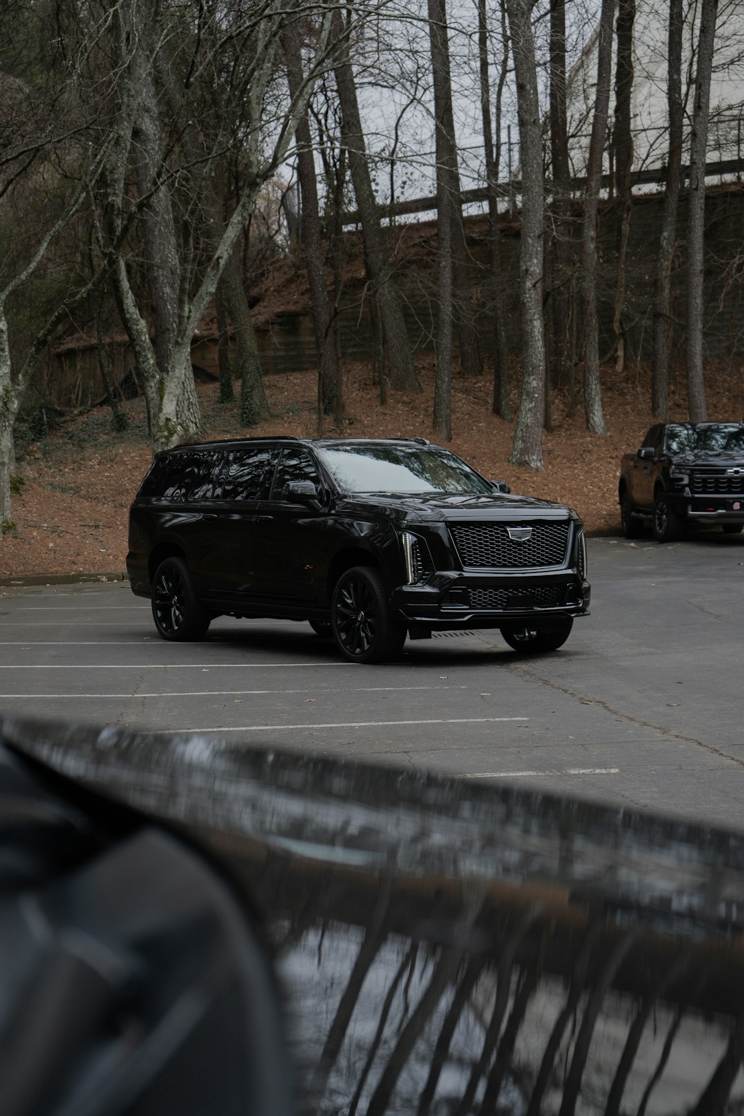 a-black-cadillac-escalade-parked-in-a-lot-9xvj-jq7ke8