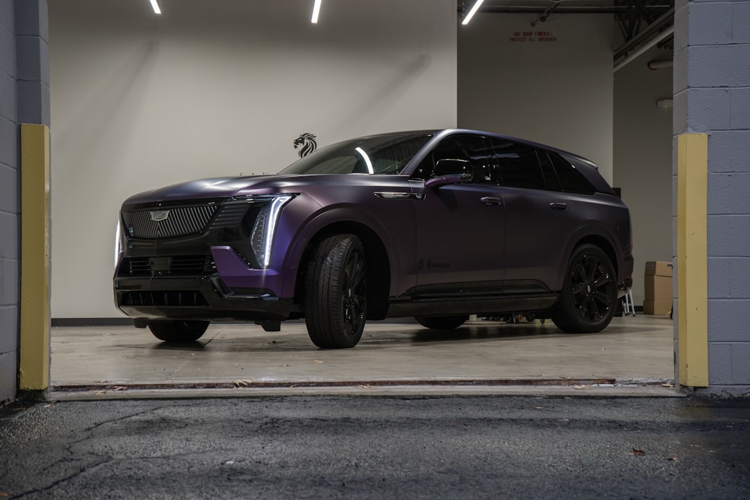 a-purple-cadillac-suv-parked-in-a-garage-d-eshmqpop0